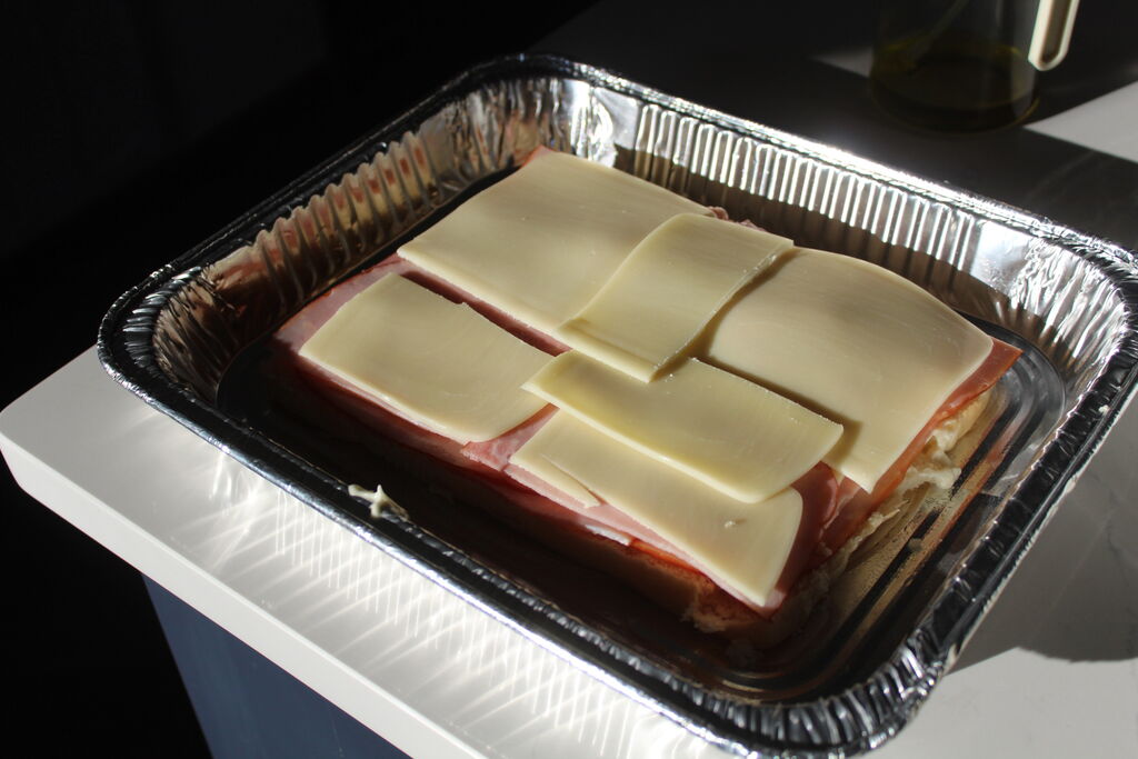 Playboy Club model Alicia Fernandez makes a batch of ham & cheese sliders for Super Bowl LIX.