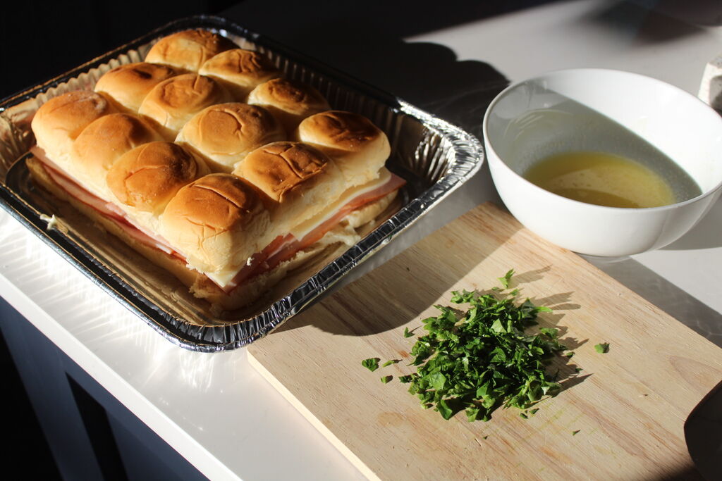 Playboy Club model Alicia Fernandez makes a batch of ham & cheese sliders for Super Bowl LIX.