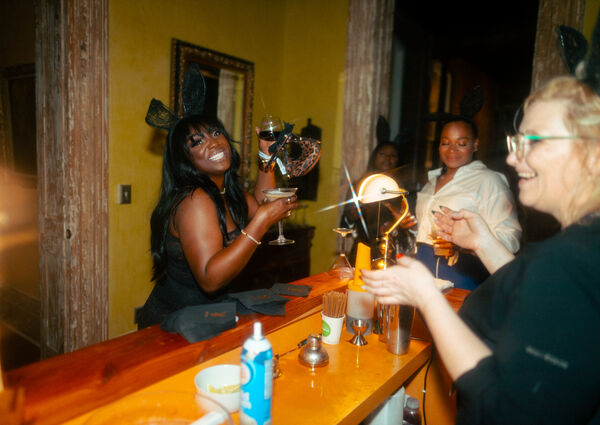 Bartender at The Block serving a cocktail to a party guest