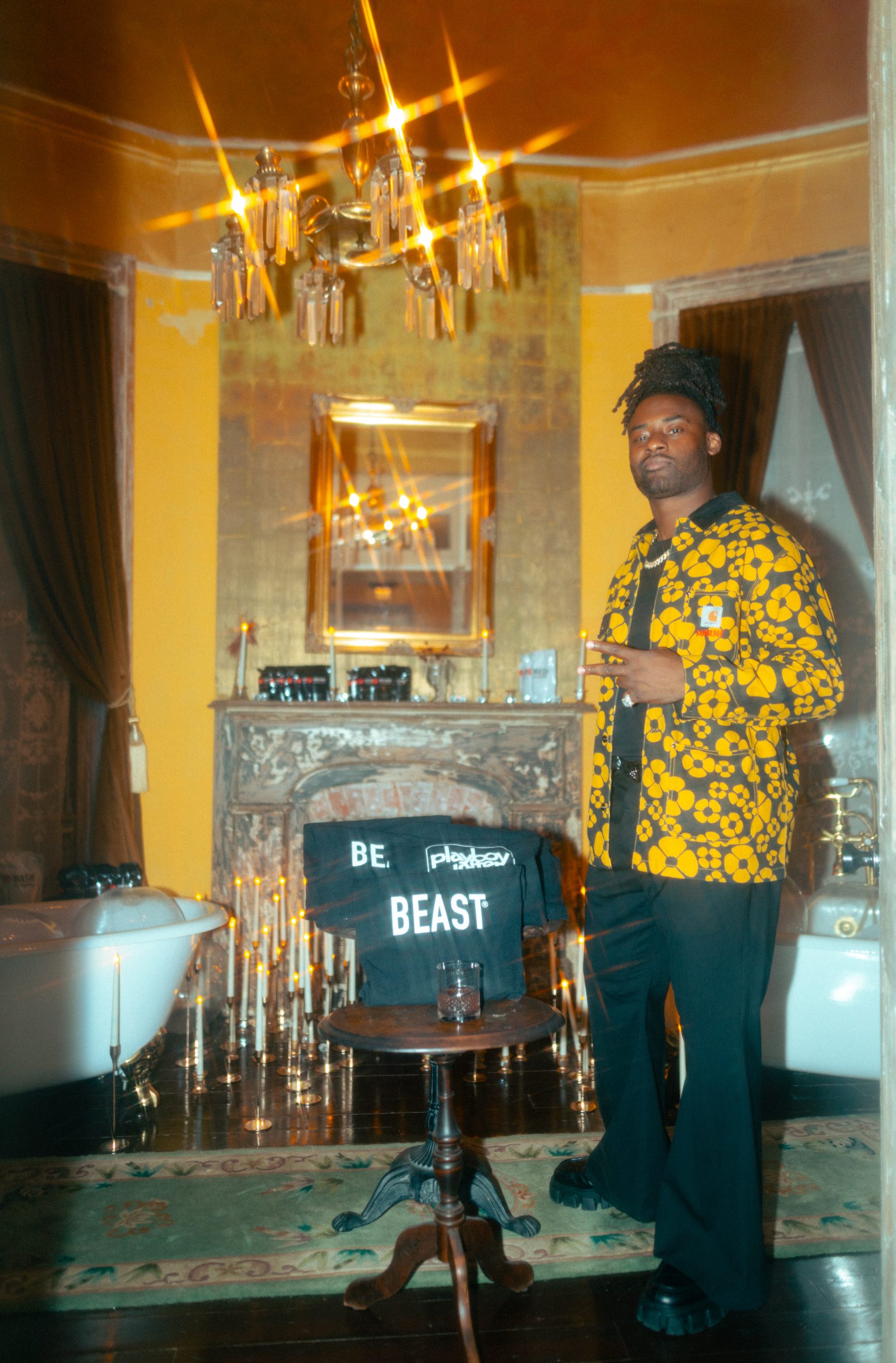 Johnathan Cyprien poses next to Beast's official merchandise